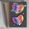 Notebook with geometric heart and arrow stickers on a gray background