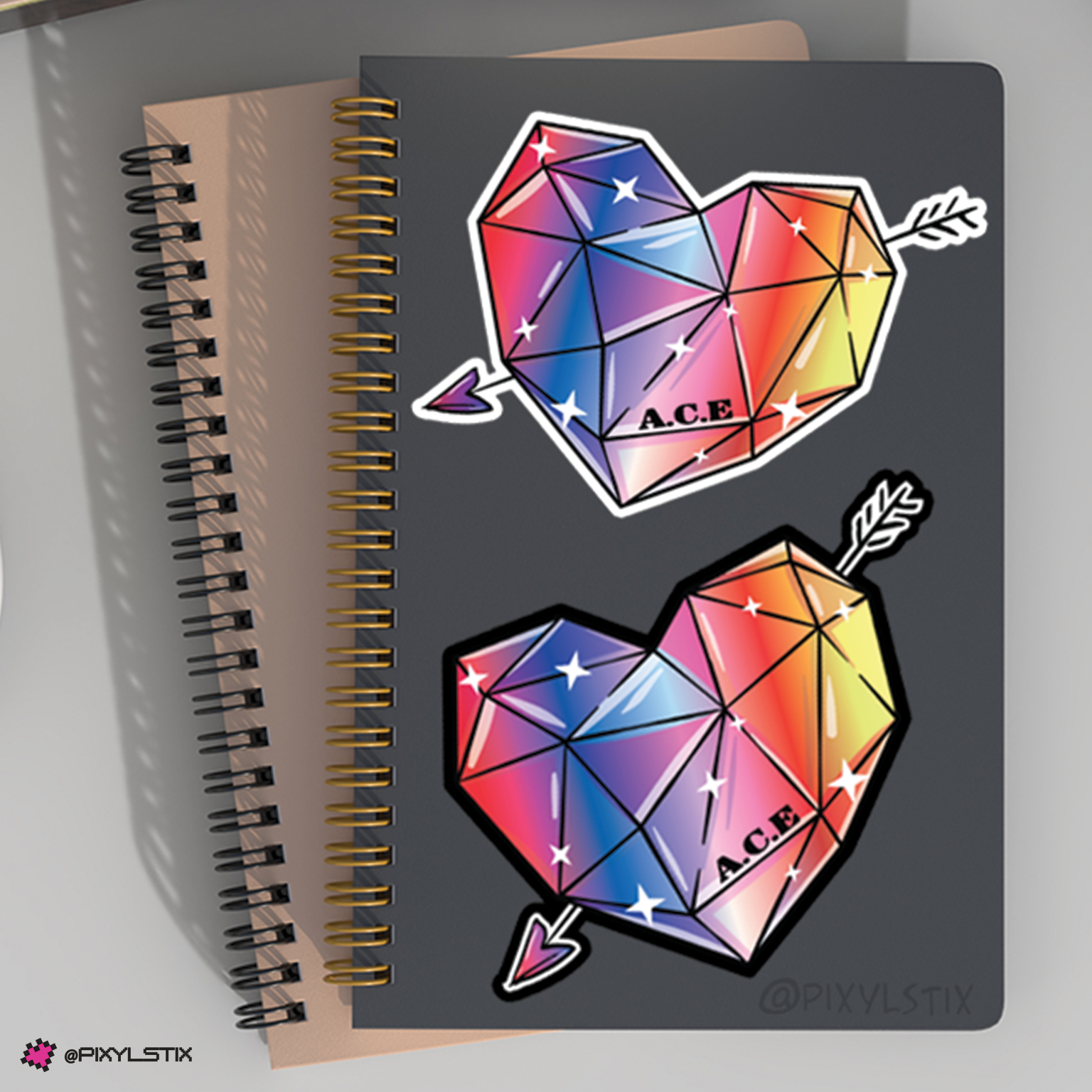 Notebook with geometric heart and arrow stickers on a gray background