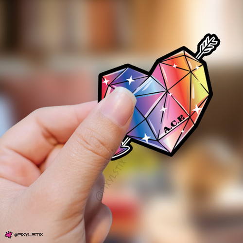 Hand holding a colorful gemstone-shaped sticker with 'A.C.E.' branding against a blurred background.