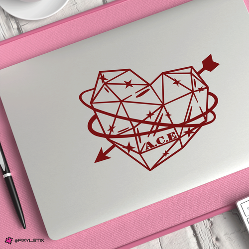 Geometric heart design with arrows on a closed laptop on a pink mat