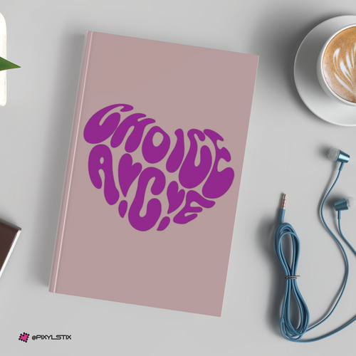 Pink notebook with purple text on a white surface with a cup of coffee and earbuds.