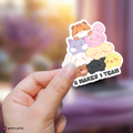 Hand holding a colorful sticker with aniteez and text against a blurred background