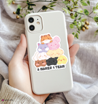 Phone case with aniteez group sticker and text held by a hand on a soft fabric background