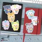 Set of mighteez stickers with rainbow hearts on a desk with a keyboard and coffee cup.