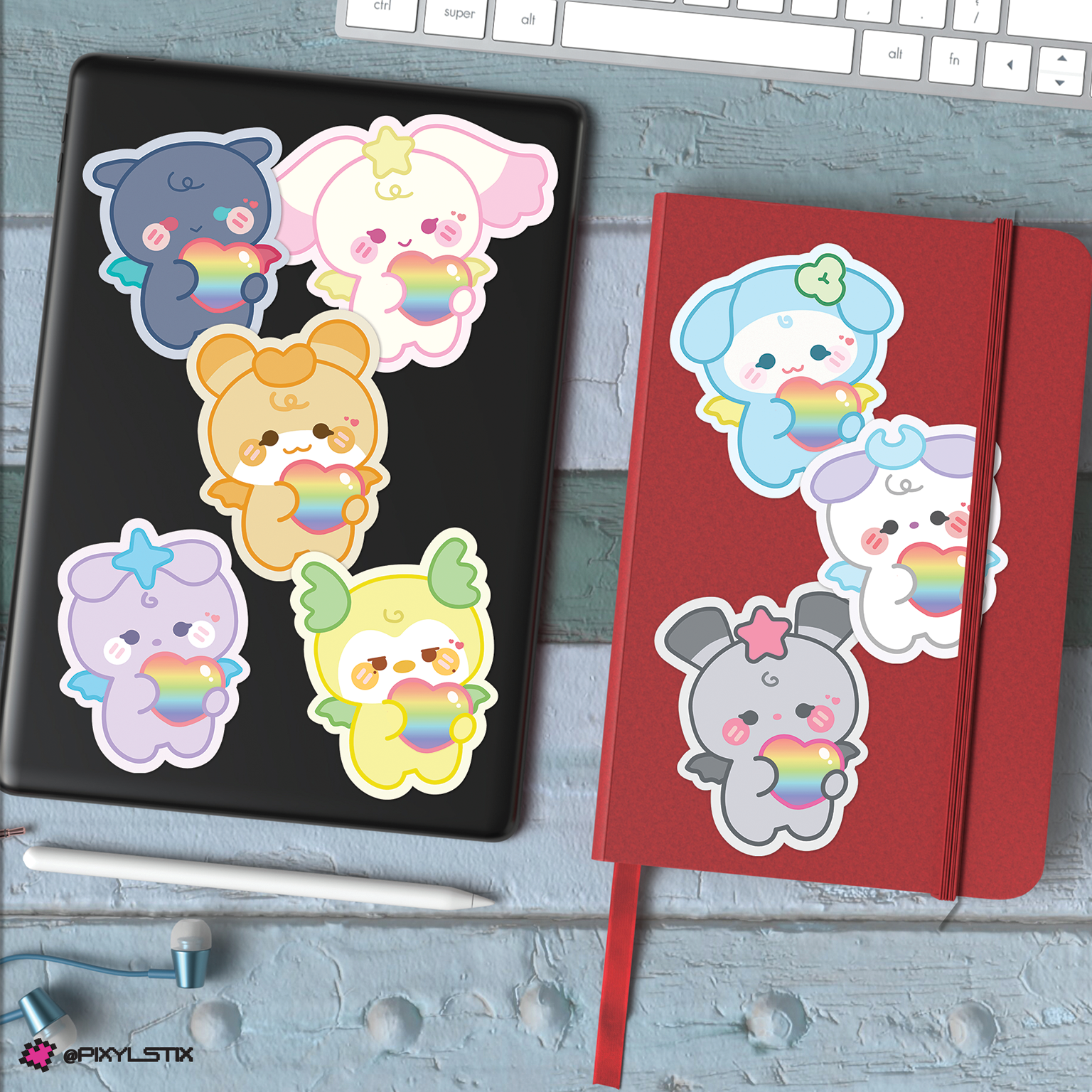 Set of mighteez stickers with rainbow hearts on a desk with a keyboard and coffee cup.