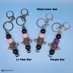 Keychains with bat designs and color options on a blue background