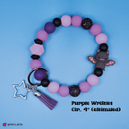 Colorful beaded bracelet with a bat charm and star keychain on a blue background