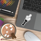 Laptop with a sticker on a desk next to a mug of hot chocolate, cinnamon sticks, and office supplies.