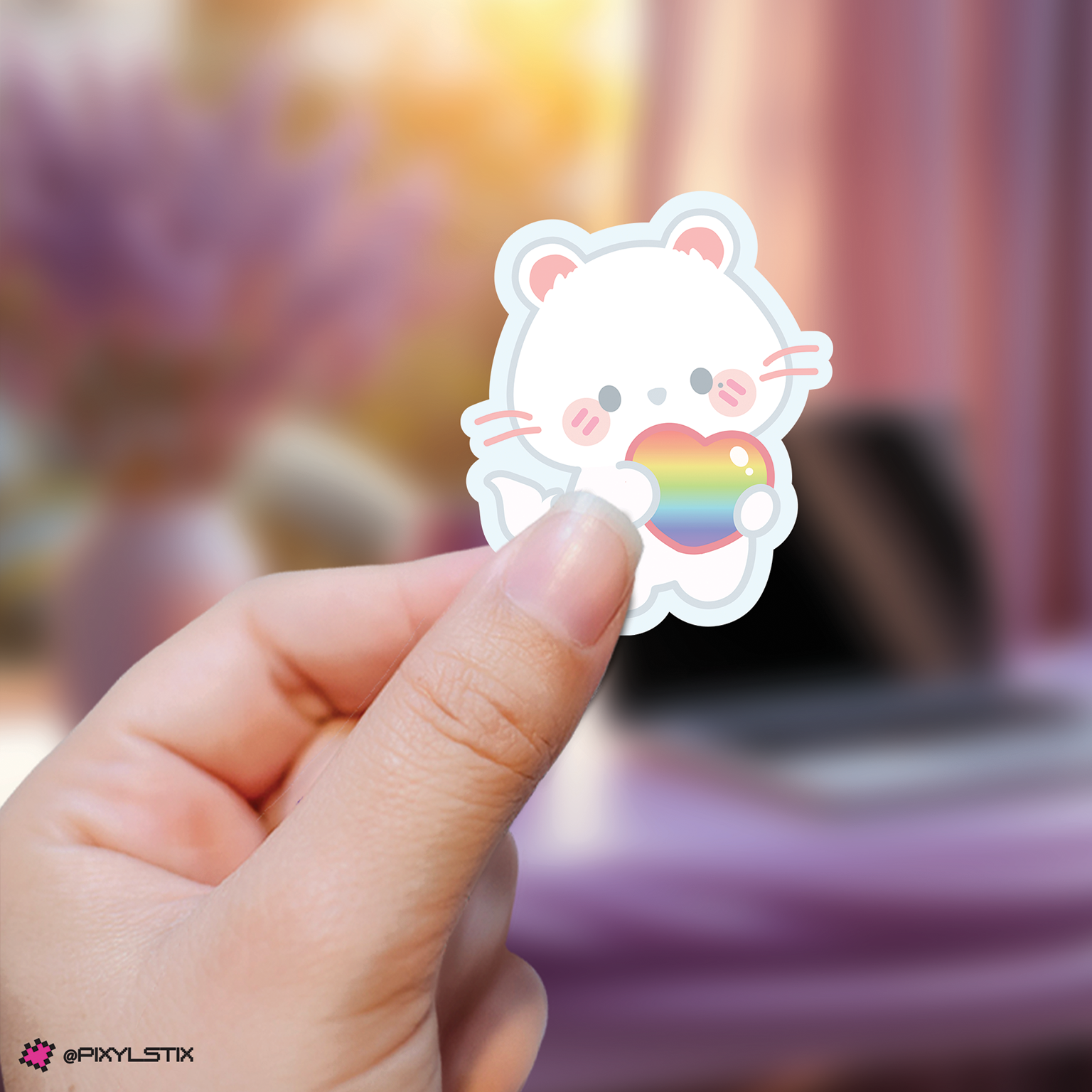 Hand holding a hyunjin skzoo sticker with a rainbow heart against a blurred background
