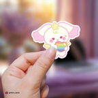 Hand holding a yeosang mighteez sticker with a rainbow heart against a blurred background