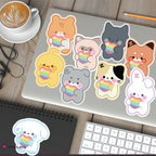 Zeroni pride stickers on a laptop with a cup of coffee and keyboard in the background