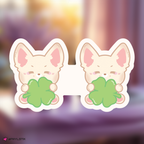 skzoo foxl.ny bookmark holding clover leaves on a blurred background