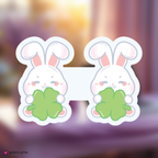skzoo leebit bookmark holding clover leaves on a blurred background