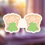 skzoo puppym bookmark holding clover leaves on a blurred background