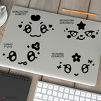 four mgihteez decals shown on a closed laptop on a desk with a keyboard and notepad