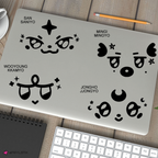four mighteez decals on a closed laptop on a desk with a keyboard and notepad