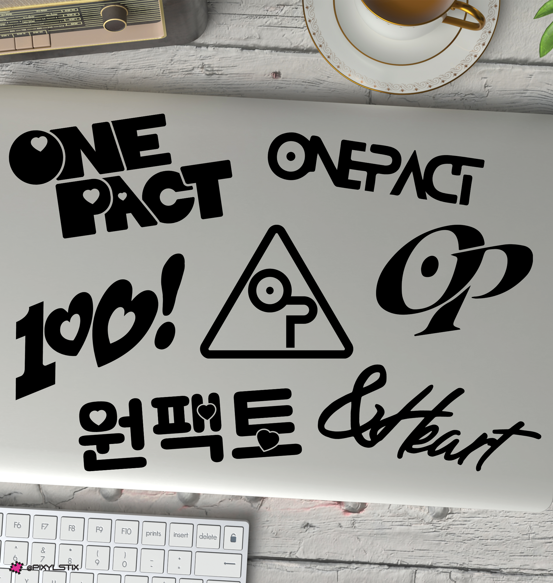 One Pact logos and text on a white surface with a keyboard and cup in the background