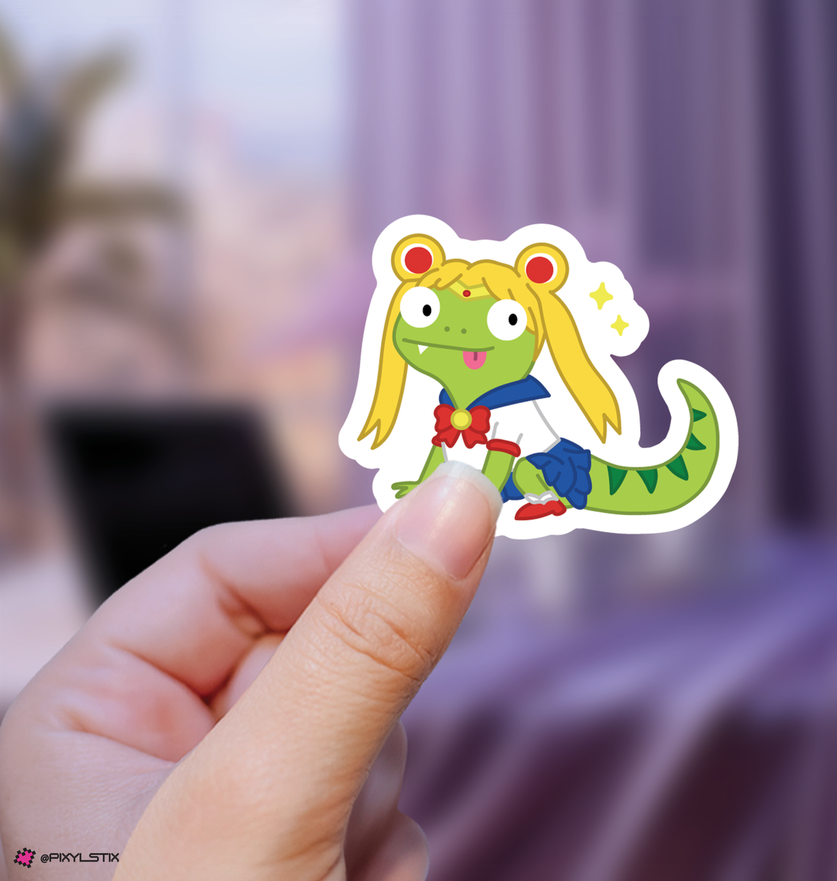 A die-cut vinyl sticker of a lizard with blonde hair, held by a person's fingers against a soft, blurred purple background.