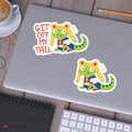 set of cartoon lizard stickers with yellow hair on a silver laptop.