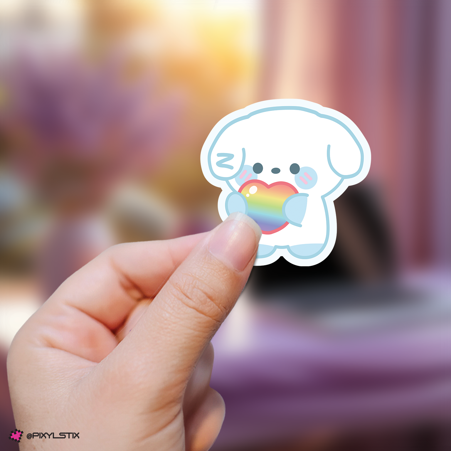 Hand holding a zeroni gyuvin sticker with a rainbow heart against a blurred background