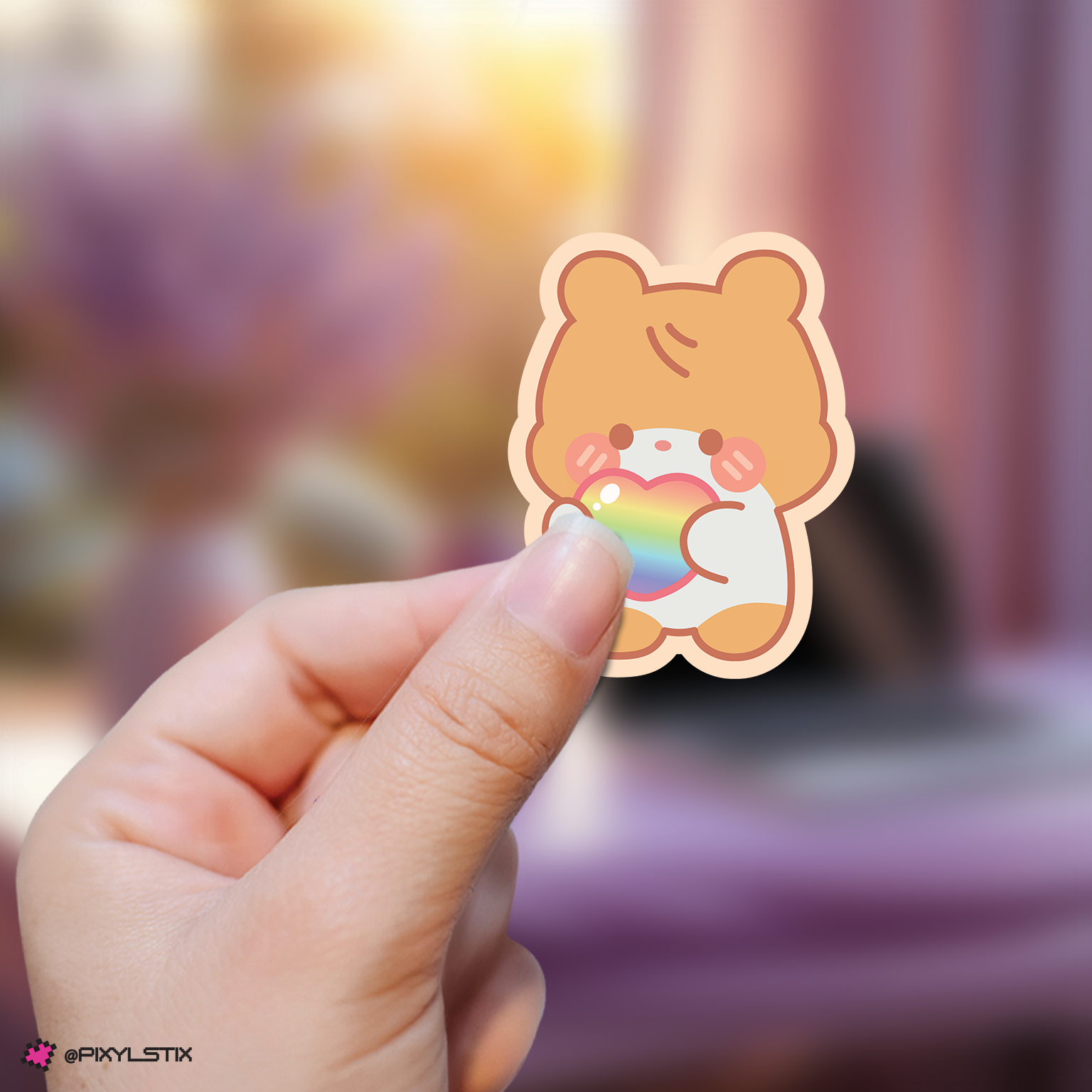 Hand holding a zeroni hanbin sticker with rainbow colors against a blurred background