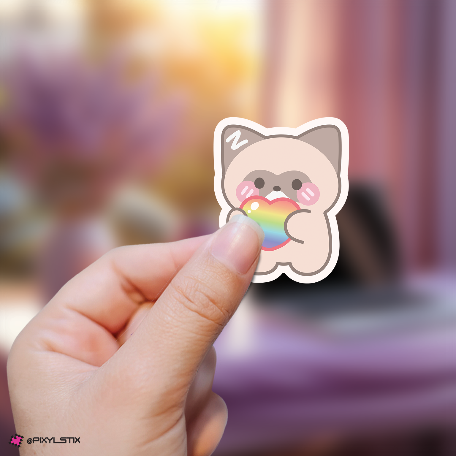 Hand holding a zeroni zhanghao sticker with a rainbow heart against a blurred background